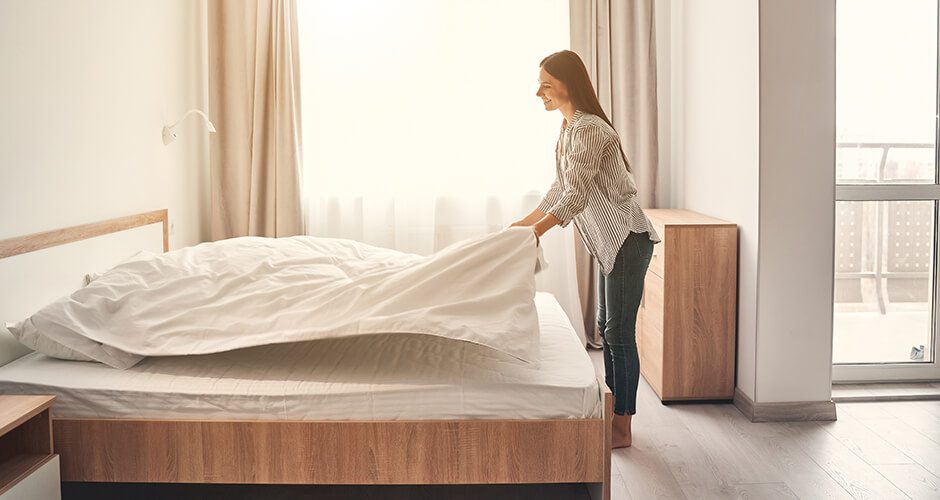 woman making bed